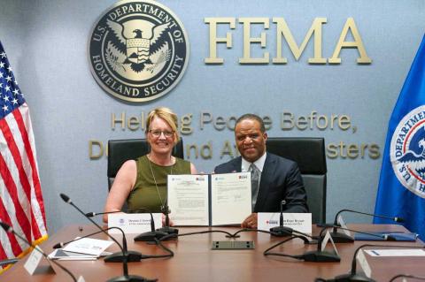 Caption: FEMA Administrator Deanne Criswell and&nbsp;Founder and CEO of Operation HOPE&nbsp;John Hope Bryant holding the signed agreement.