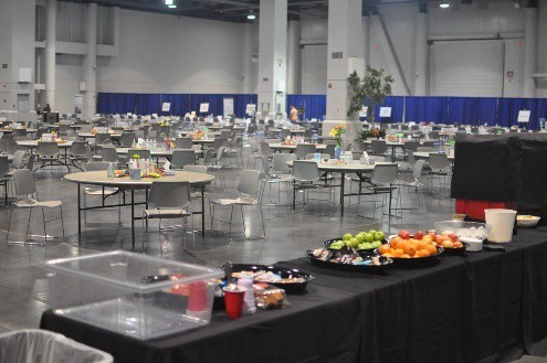A large area with tables and food set up for families.