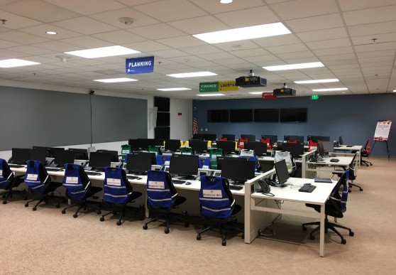 A large EOC room with computers and chairs.