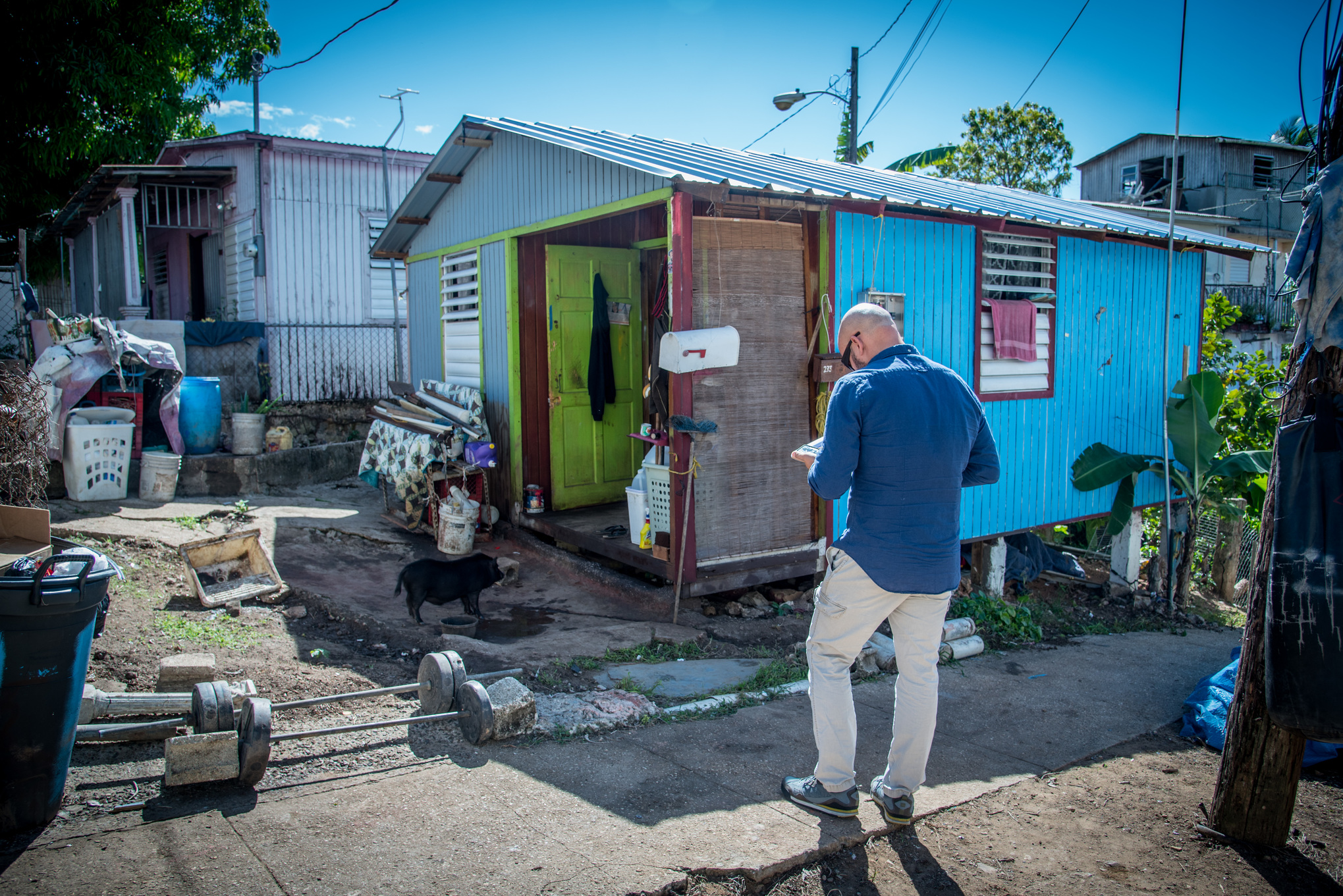 FEMA Specialist standing outside a rebuild house in Aguada