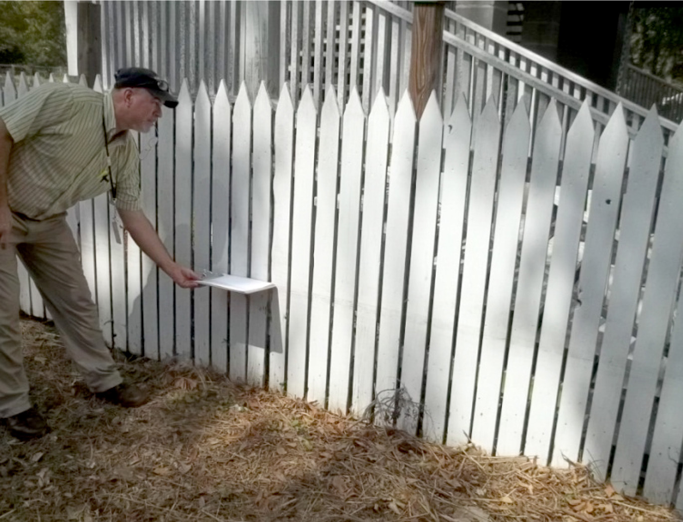 LAS team member measuring high water mark on a picket fence
