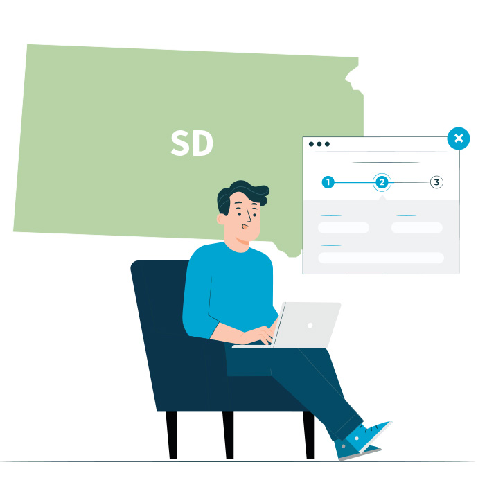 A man sitting in a chair on his laptop filling out an application with the state of South Dakota in the background.