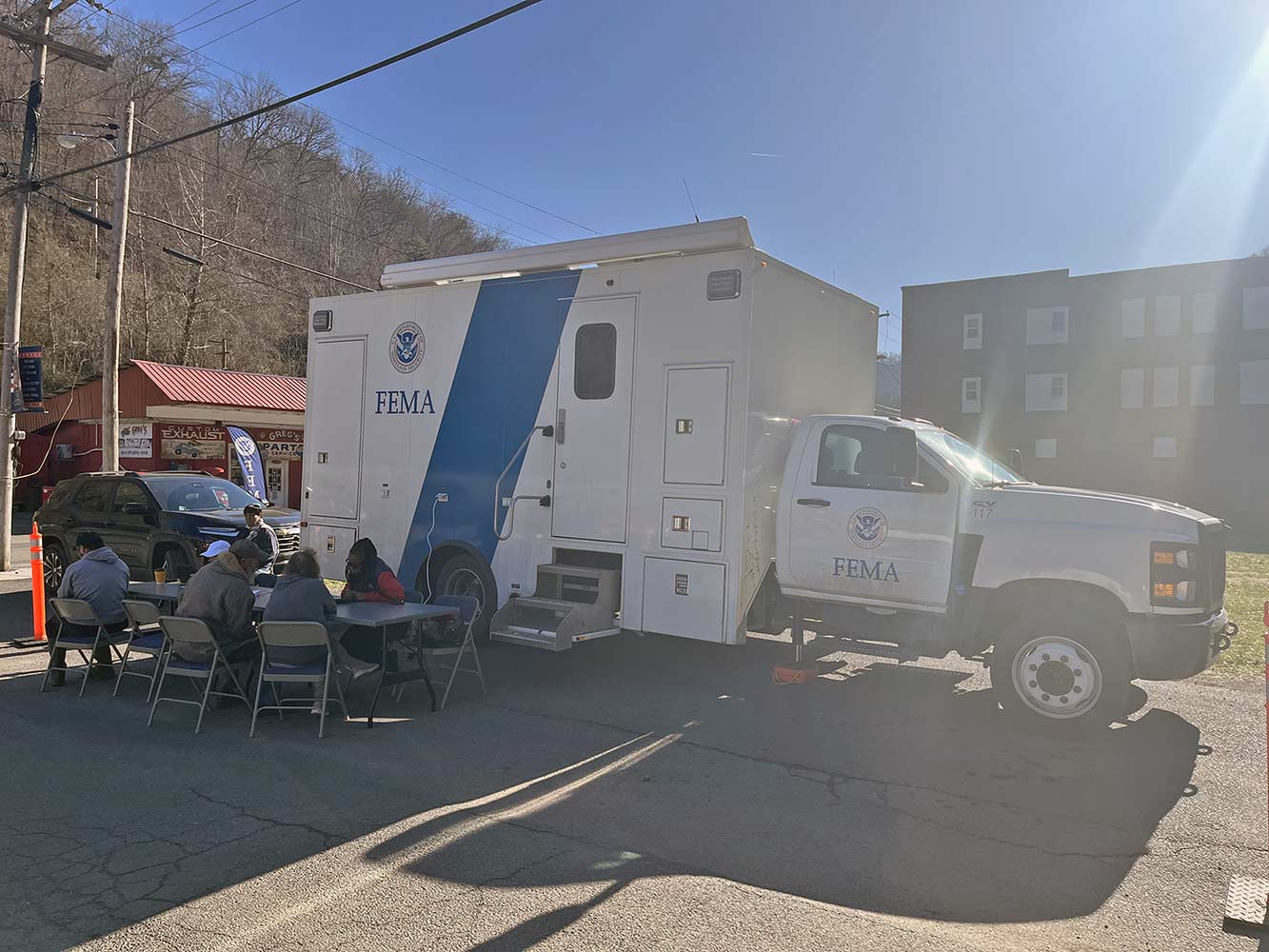 FEMA is Reaching Out to West Virginians by PhoneLearn more at www.fema.gov/disaster/4861 March 2025    3 FEMA staff supporting residents next to a mobile communications vehicle.