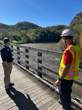 Photo shows FEMA and local officials surveying debris in Claytor Lake.