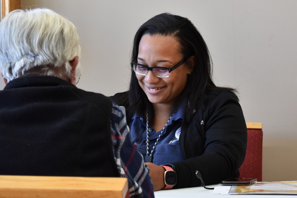 FEMA staff member at the DRC in Tazewell, Va. helping a resident impacted by Helene apply for disaster assistance