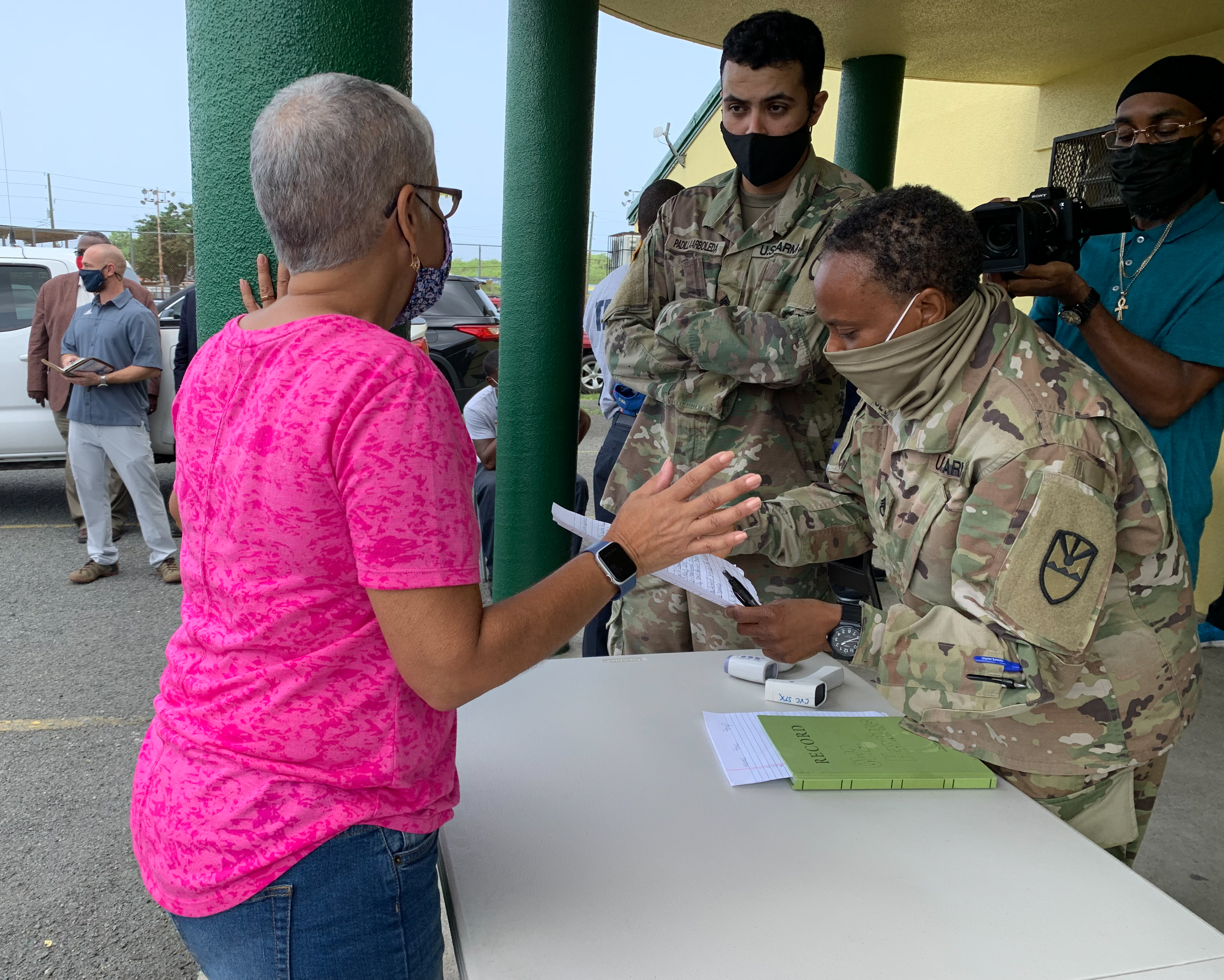 A volunteer acting as an evacuee checks in with the Virgin Islands National Guard during an evacuation shelter drill at D.C. Canegata Recreation Center on St. Croix.