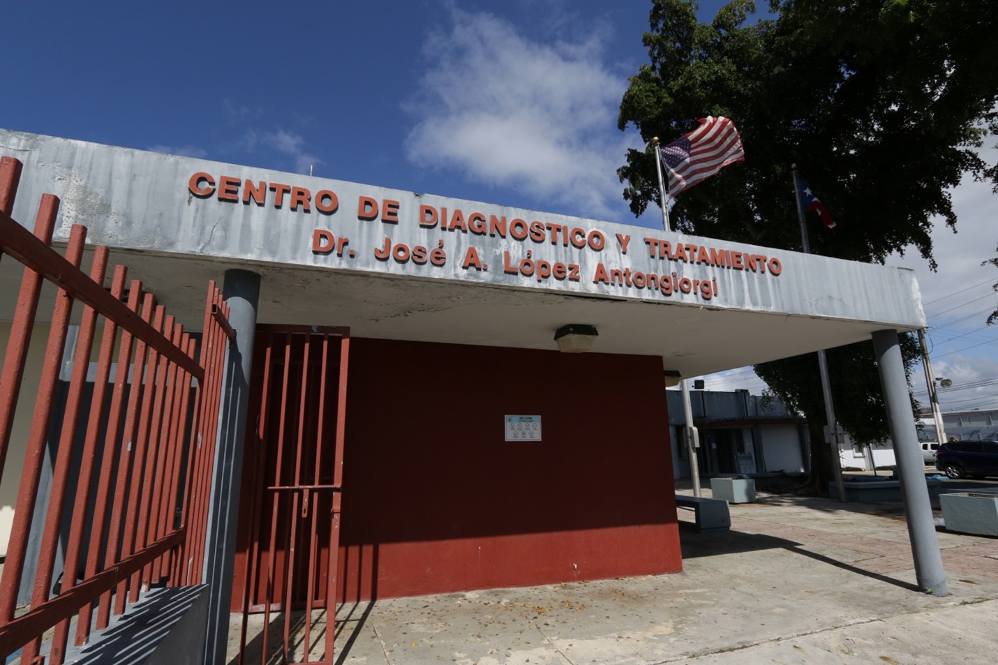 Red and white building with red gate