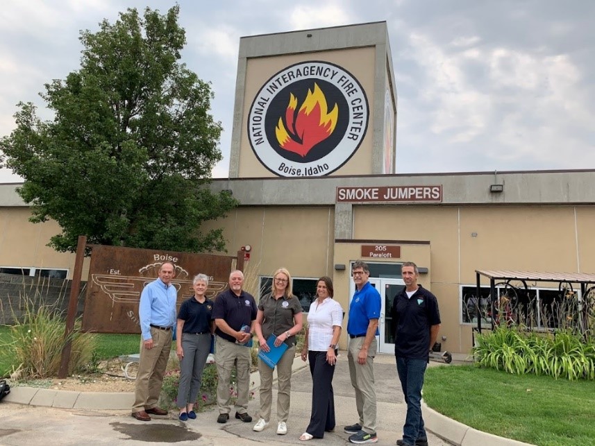 From left, Idaho Office of Emergency Management Director Brad Richy, acting U.S. Fire Administrator, Chief Tonya Hoover, FEMA Region 10 acting Administrator Vince Maykovich, FEMA Administrator Deanne Criswell, White House National Security Council representative Caitlin Durkovich, USFA representative Aitor Bidaburu and NIFC representative Grant Cogswell outside of the Smoke Jumpers base at the NIFC.