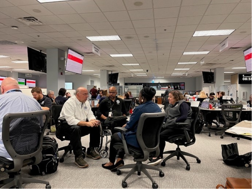 Federal Coordinating Officer Timothy S. Pheil discussing the disability integration strategy for the Hurricane Helene response with FEMA Disability Coordinator Sherman Gillums Jr. along with state access and functional needs staff in the situation room at the Virginia Emergency Operations Center.  