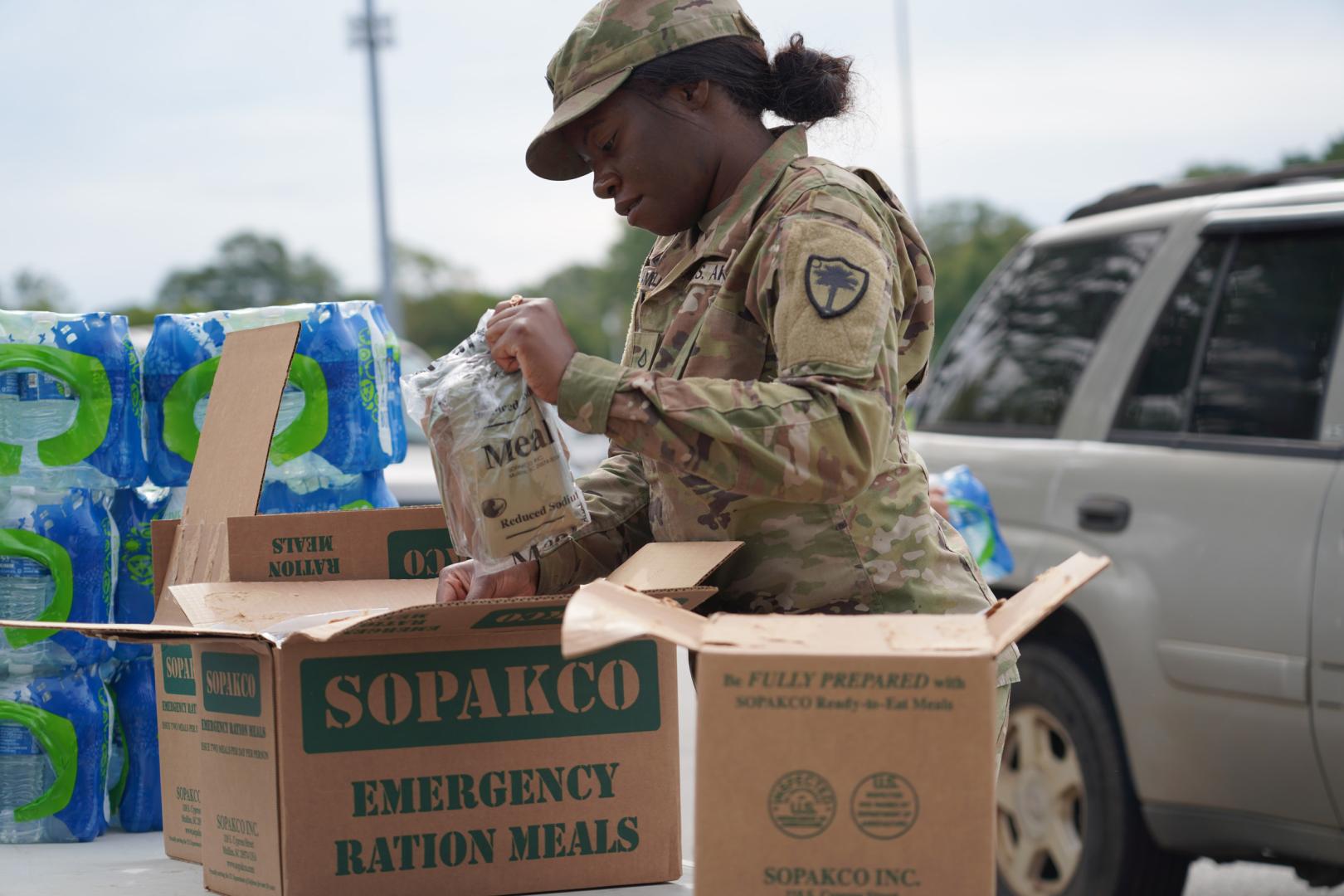 Members of the South Carolina Army National Guard distribute meals and water to disaster survivors in Greenville. 