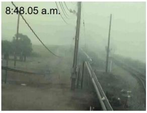 Image from earlier in text : Security camera photograph showing chlorine vapor cloud moving through the area. Same security camera photograph showing chlorine vapor cloud moving through the area, with a visibly denser cloud, only 10 minutes later.