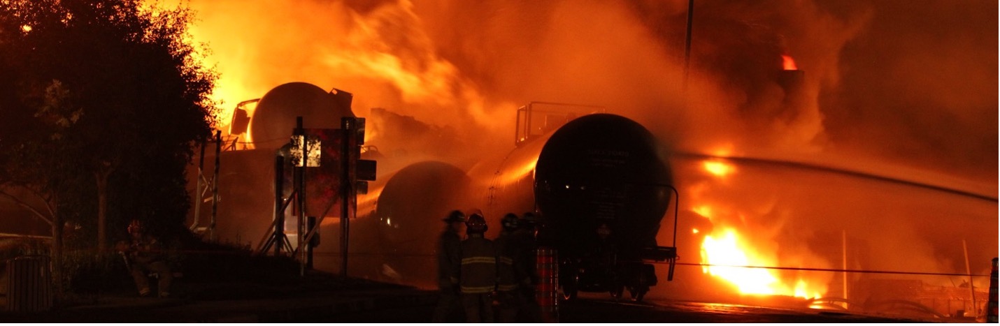 Image from earlier in text: Rail cars on fire