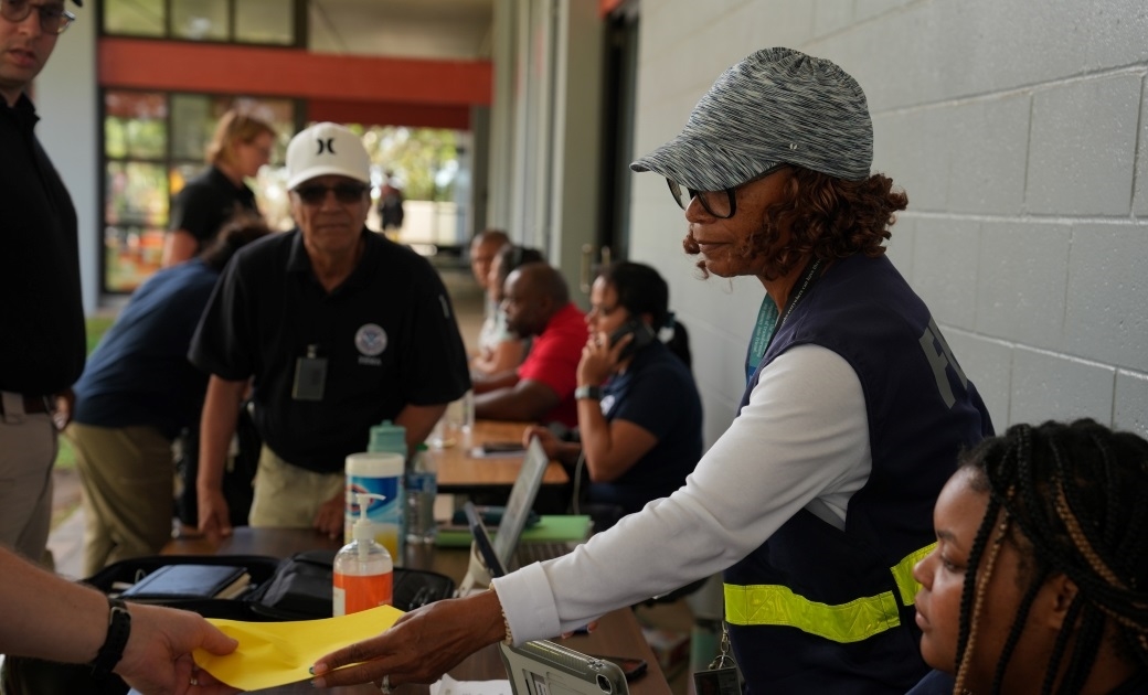 A FEMA employee in a Disaster Recovery Center working with survivors.