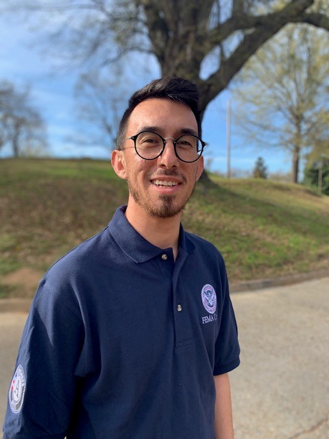 A man smiling in a park