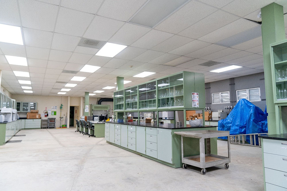 Inside view of laboratory with green stands full of equipment.