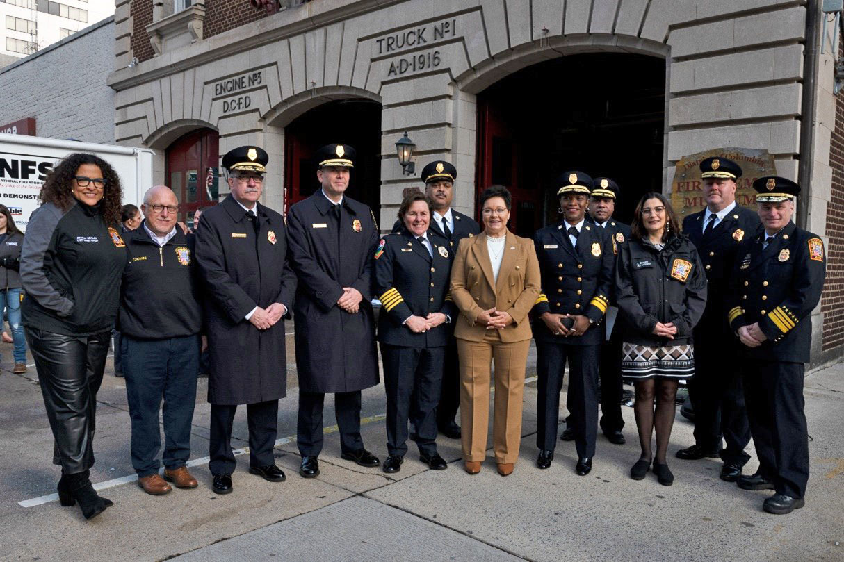 U.S. Fire Administrator Dr. Lori Moore-Merrell (center right) and International Association of Fire Chiefs President Chief Donna Black (center left) stand with members of the Washington, D.C., Fire Department. 