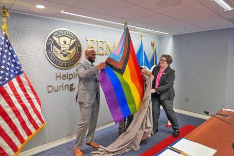 Caption: <p>WASHINGTON<em>&nbsp;-- </em>FEMA employees DeMarques Coleman and Caitlin Heavey unveil Progressive Pride Flag at FEMA Headquarters in Washington D.C.</p>