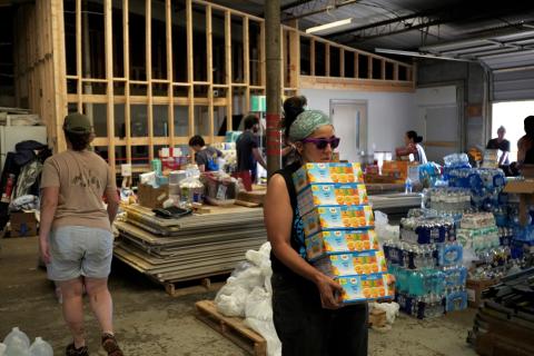 Caption: Asheville, NC (Oct. 1, 2024) - Volunteers distribute supplies to those affected by Hurricane Helene.