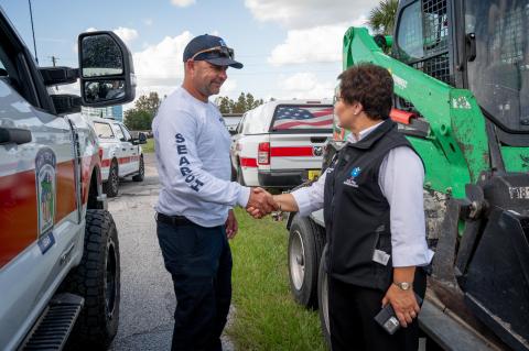 Caption: Tampa, FL - After Hurricane Milton, U.S. Fire Administrator Dr. Lori Moore-Merrell makes a visit to Tampa and talks with Chris Whitler of Task Force 8, a Florida search and rescue team that primarily focuses on water-based rescues.