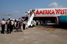 Another commercial jetliner boards evacuees for their flight out of the city to shelters now being set up in cities throughout the country. Military, commercial and private airplanes evacuated tens of thousands of residents from the New Orleans Airport. 