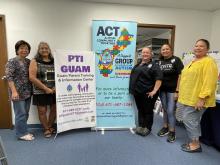 Representatives from PIT stand to the left of a standing sign that says PIT Guam. In the center of the photo is a sign that states ACT (Autism Community Together). On the right side of the picture are representatives from FEMA and ACT from left to right..