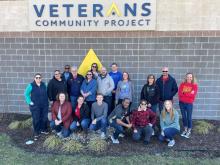 Group of volunteers serve the veterans community project. 