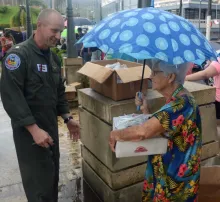  Cmdr. Jeremy Anderson, the operations officer at Coast Guard Air Station Borinquen, Puerto Rico, delivers food and water to a resident of Moca, Puerto Rico, Oct. 9, 2017. The Coast Guard and partner agencies have been delivering Federal Emergency Management Agency supplies to people throughout Puerto Rico who have been affected by Hurricane Maria. U.S. Coast Guard photo by Petty Officer 3rd Class David Micallef