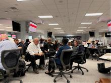 Federal Coordinating Officer Timothy S. Pheil discussing the disability integration strategy for the Hurricane Helene response with FEMA Disability Coordinator Sherman Gillums Jr. along with state access and functional needs staff in the situation room at the Virginia Emergency Operations Center.