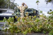 Florida Army National Guard Soldiers with the 3rd Battalion, 116th Field Artillery Regiment, check in with a resident and clear debris following Hurricane Milton 