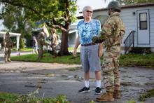 Florida Army National Guard Soldiers with the 3rd Battalion, 116th Field Artillery Regiment, check in with a resident and clear debris following Hurricane Milton 